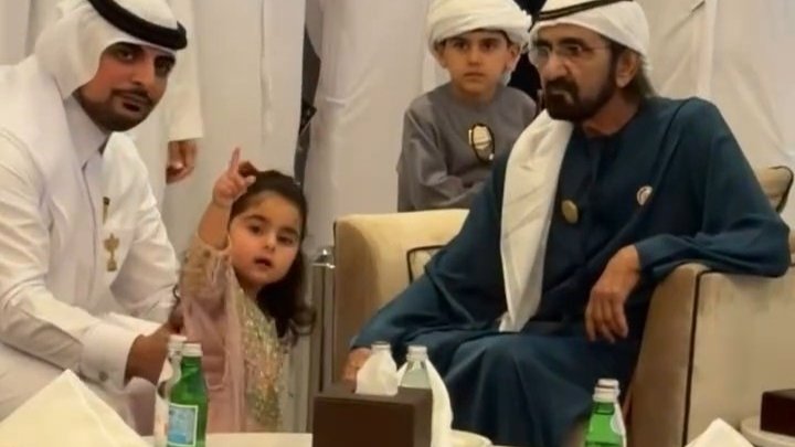 Dubai's ruler and his grandchild at the sidelines of horse races in Dubai